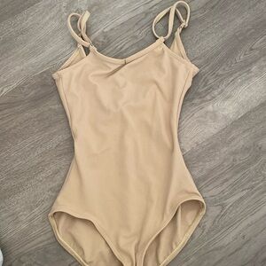don’t know if this is a bodysuit early leotard, but it’s tan and never been worn